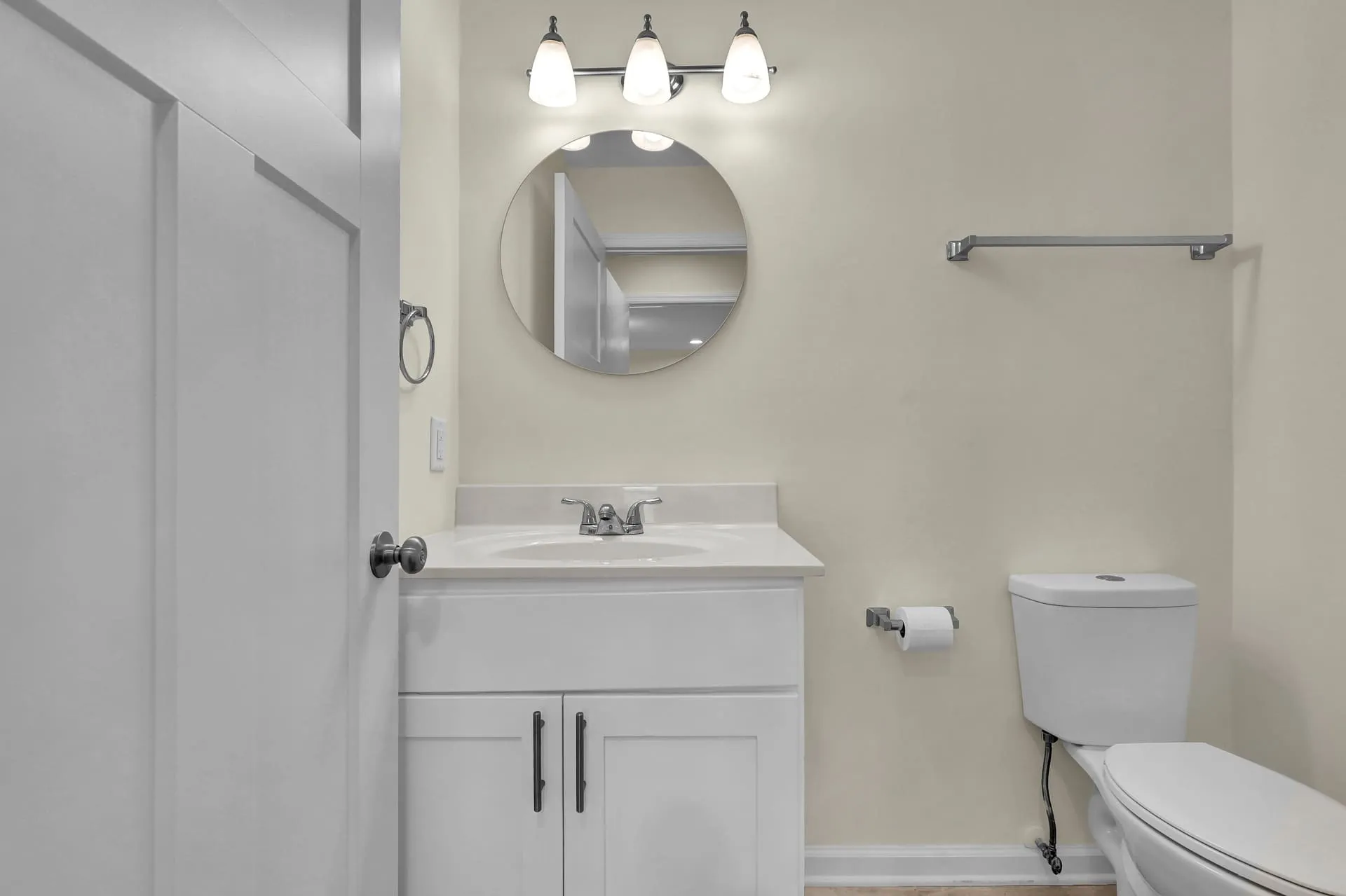 Half bath with round mirror vanity