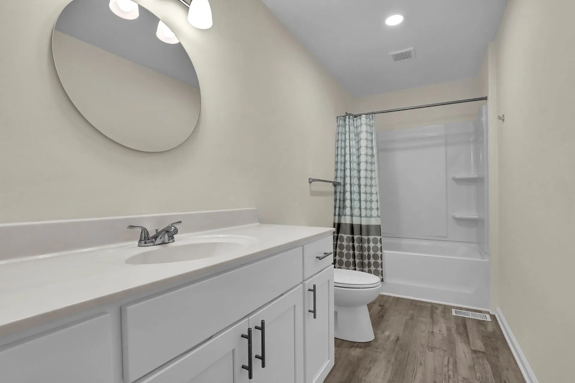 Full bathroom with long vanity and tub shower