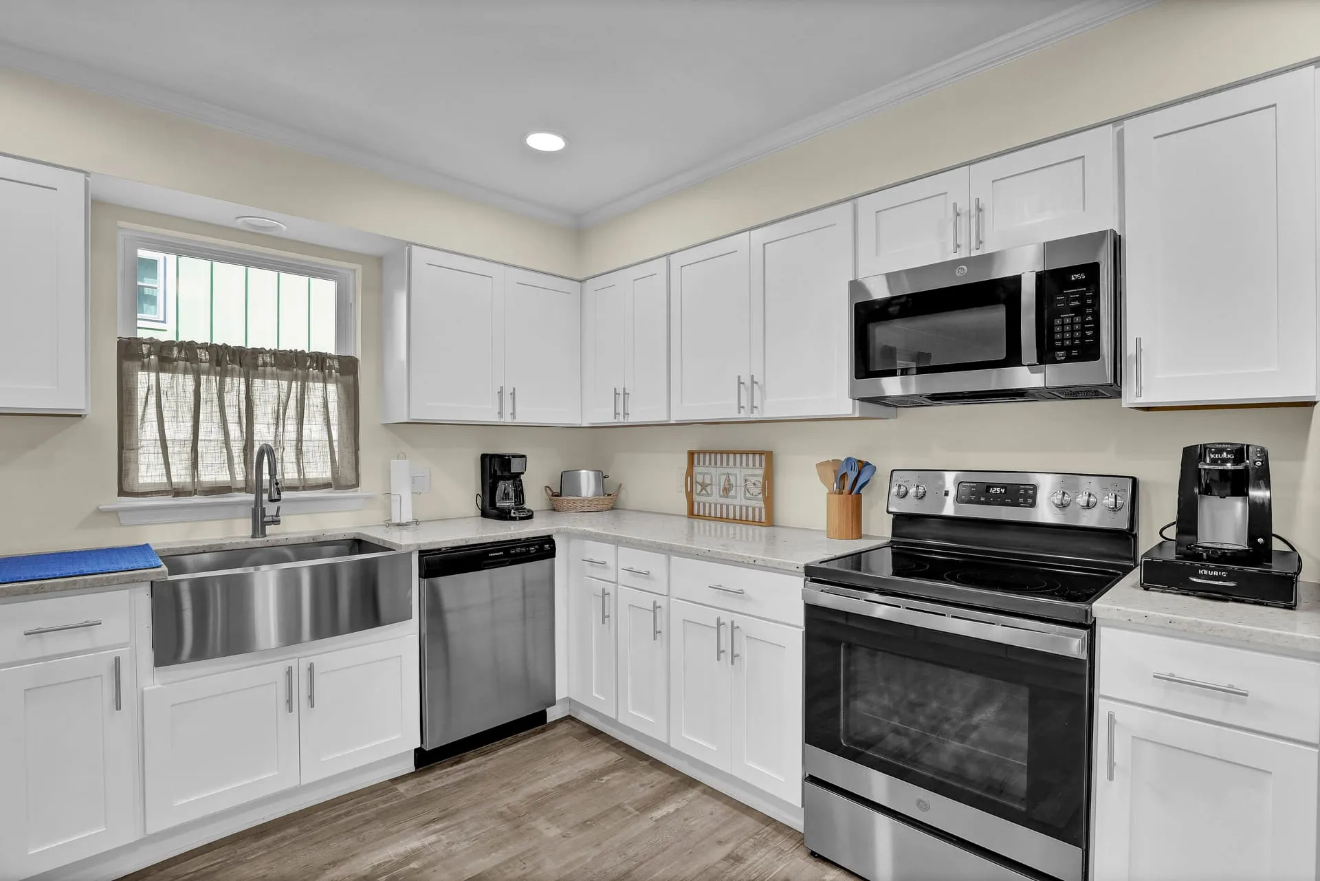 Farmhouse sink, stainless appliances, and coffee station