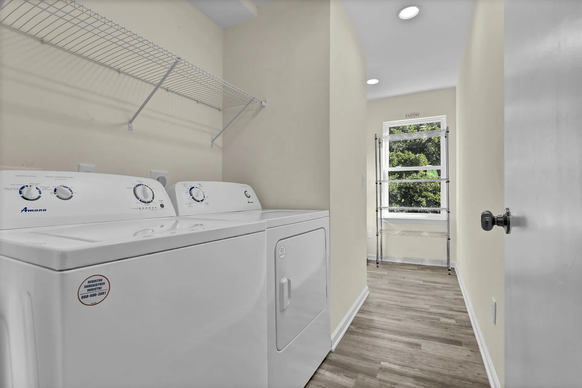 Laundry room with washer, dryer, and pantry shelving