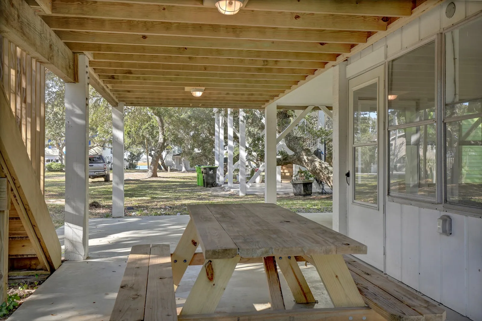 Covered outdoor picnic dining beneath the house