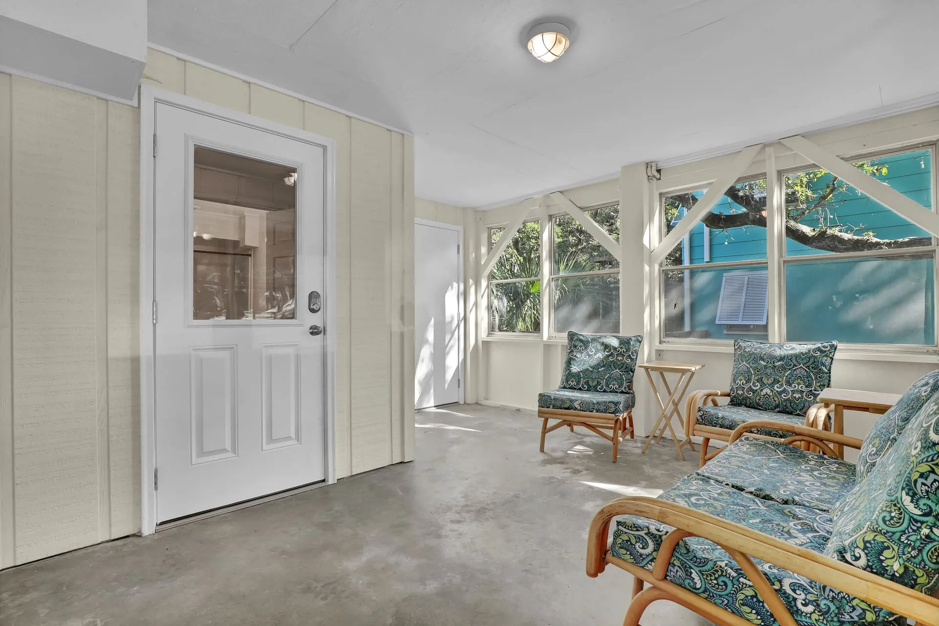 Enclosed sun porch with rattan seating